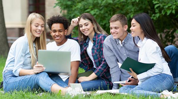 Summer School students looking at laptop